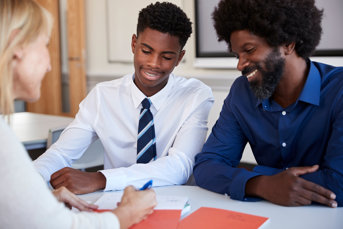 Adobestock 234477809 Student And Parent Speak With A Teacher